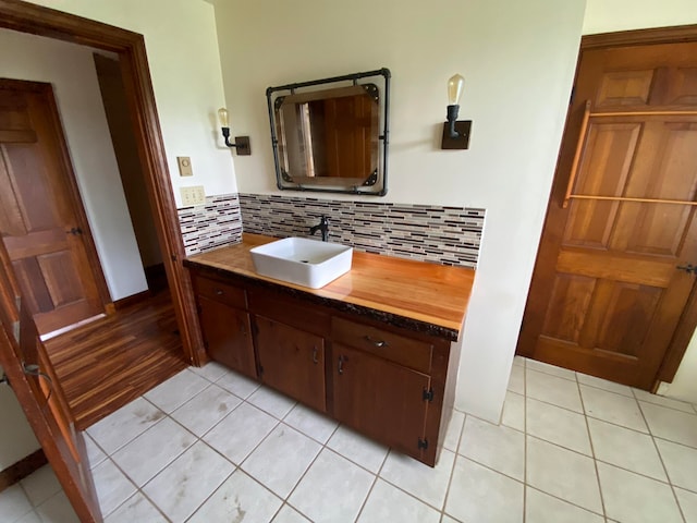 bathroom featuring hardwood / wood-style floors, vanity, and decorative backsplash