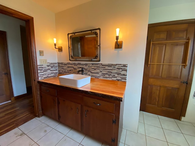 bathroom with vanity, decorative backsplash, and wood-type flooring