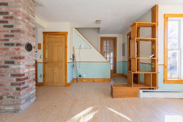 entryway featuring electric panel, a baseboard radiator, and light wood-type flooring