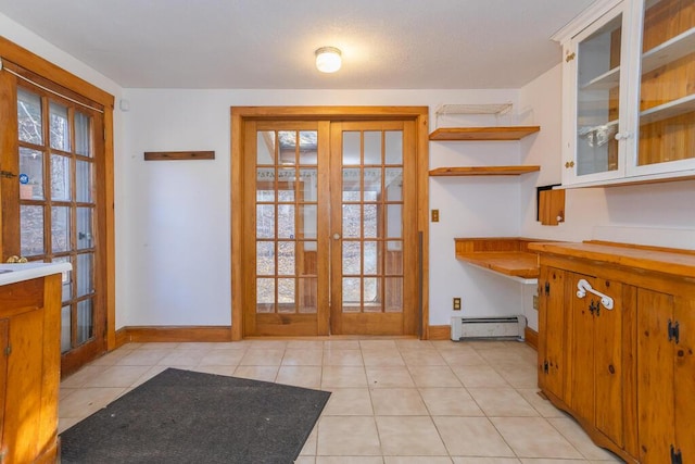 doorway featuring french doors, light tile patterned floors, and a baseboard radiator