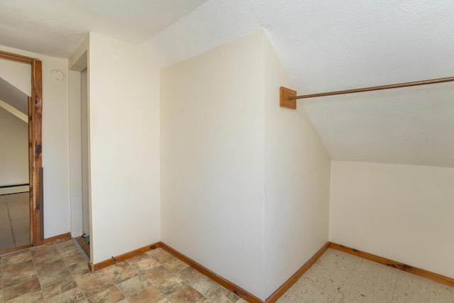 bonus room featuring baseboard heating and vaulted ceiling