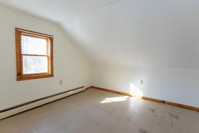 additional living space featuring lofted ceiling and a baseboard heating unit