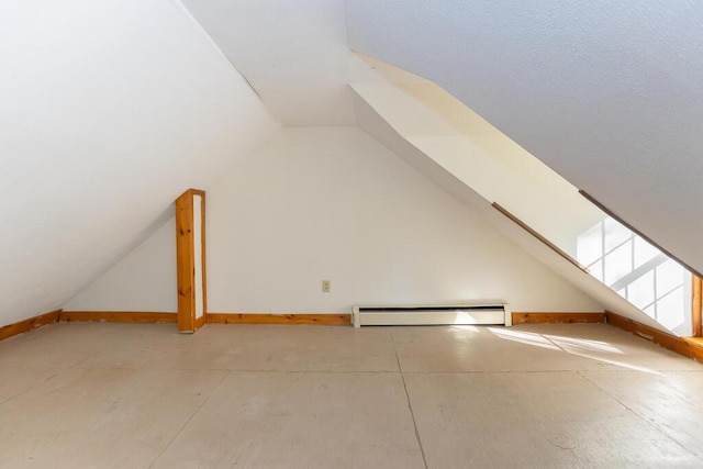 bonus room with lofted ceiling and a baseboard radiator