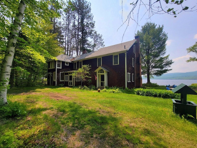 108 E Brook Ln Unit 17, Weld, ME 04285 - back of house featuring a chimney, a water view, and a yard