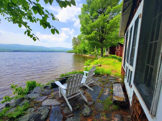 108 E Brook Ln Unit 17, Weld, ME 04285 - view of patio with a water view and an outdoor structure