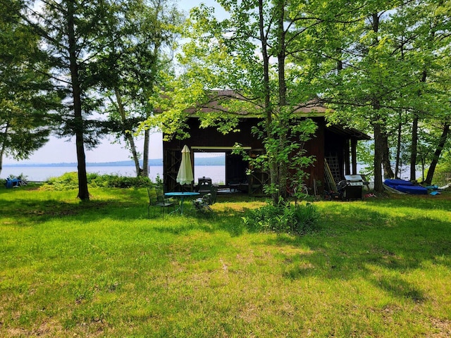 108 E Brook Ln Unit 17, Weld, ME 04285 - view of grassy yard with an outbuilding and a water view