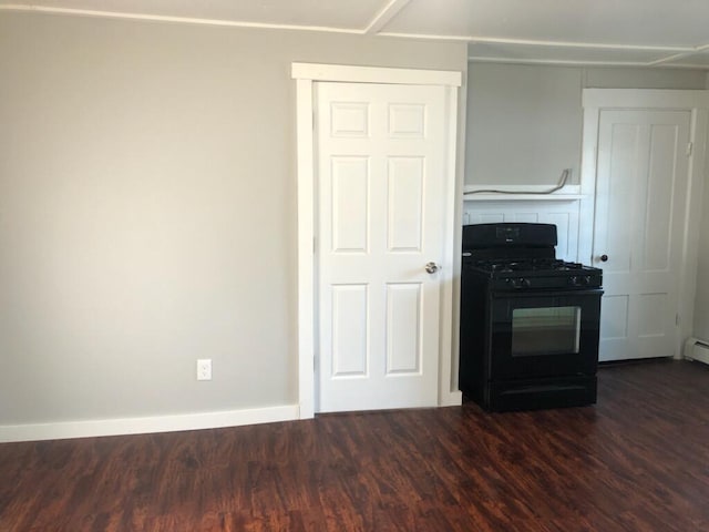 kitchen featuring black range with gas stovetop and dark hardwood / wood-style floors