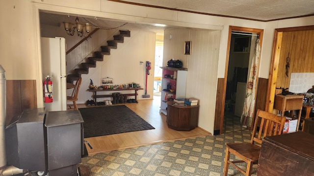 185 Knox St, Millinocket, ME 04462 - basement with tile patterned floors, stairs, crown molding, and wooden walls