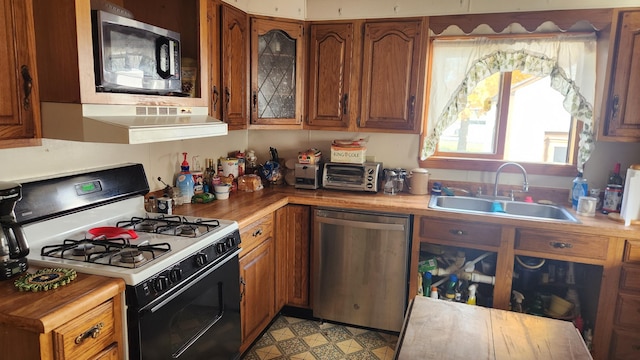 185 Knox St, Millinocket, ME 04462 - kitchen featuring stainless steel appliances, a sink, and brown cabinets