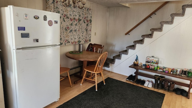 185 Knox St, Millinocket, ME 04462 - dining room featuring stairs, wood finished floors, and wooden walls