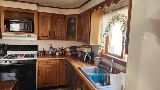 185 Knox St, Millinocket, ME 04462 - kitchen featuring stainless steel appliances, a sink, extractor fan, and brown cabinetry