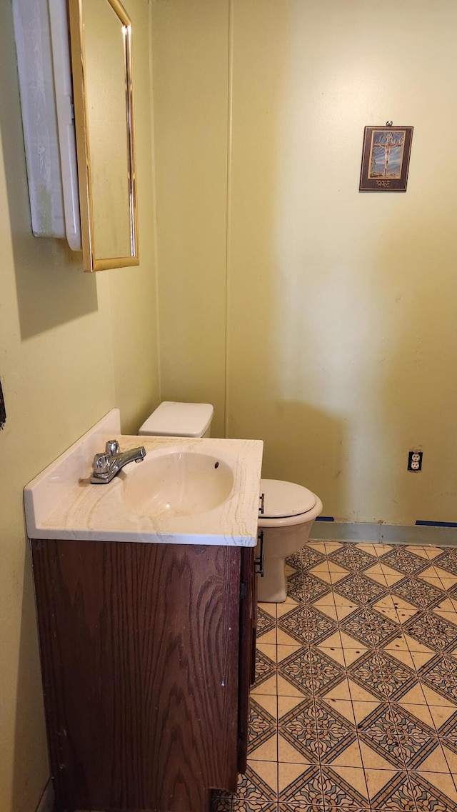 bathroom with vanity, toilet, and tile patterned flooring