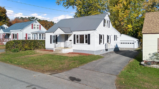 view of front of home featuring a front yard, an outdoor structure, and a garage