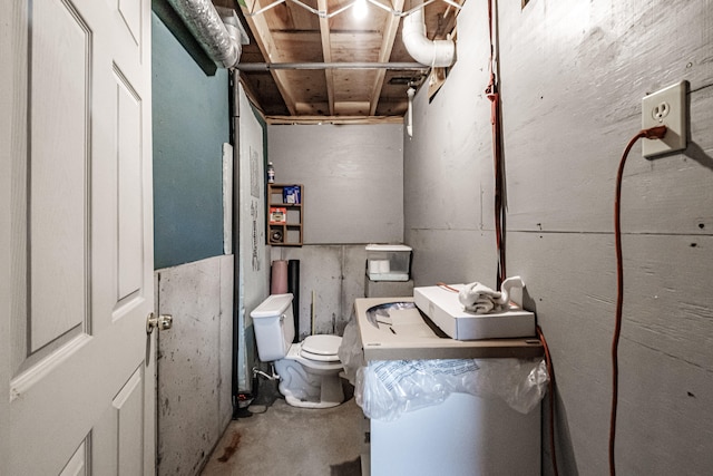 bathroom featuring concrete flooring and toilet