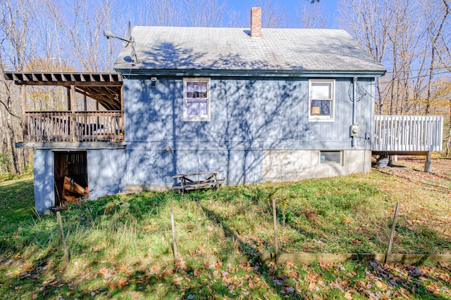 rear view of property featuring a wooden deck