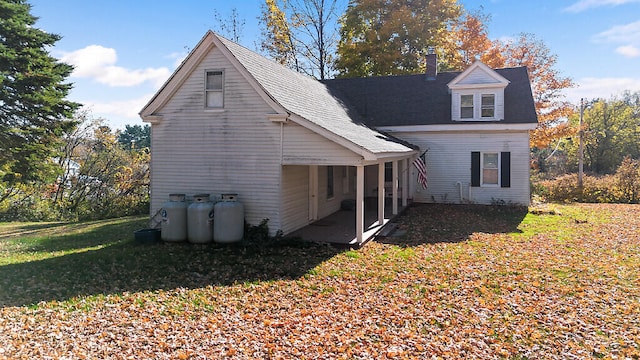 rear view of house with a lawn