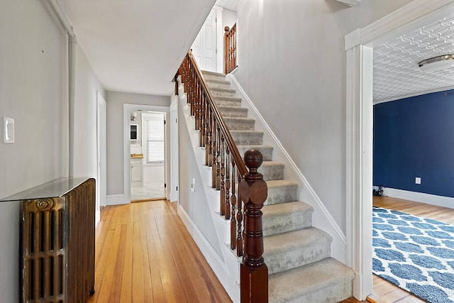 stairs featuring wood-type flooring