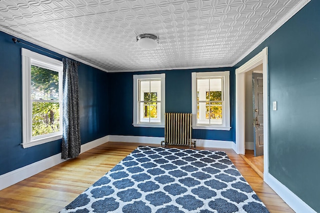 sitting room featuring ornamental molding and hardwood / wood-style floors