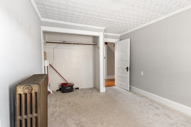 unfurnished bedroom featuring ornamental molding, light colored carpet, and radiator