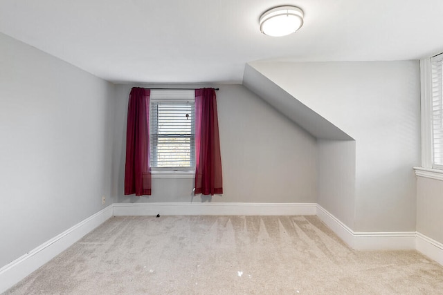 additional living space with lofted ceiling and light colored carpet