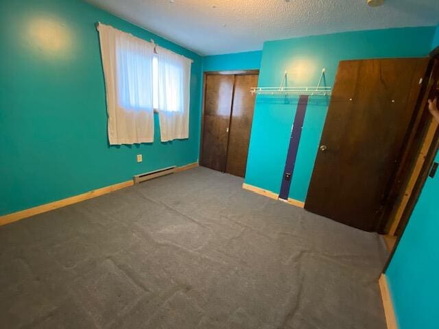 unfurnished bedroom with a closet, a baseboard radiator, carpet floors, and a textured ceiling