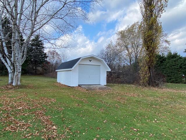 exterior space featuring a garage and a yard