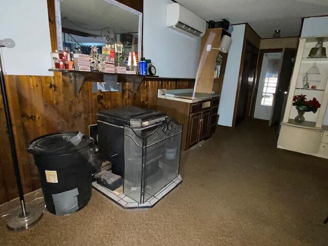 interior space with an AC wall unit and wood walls