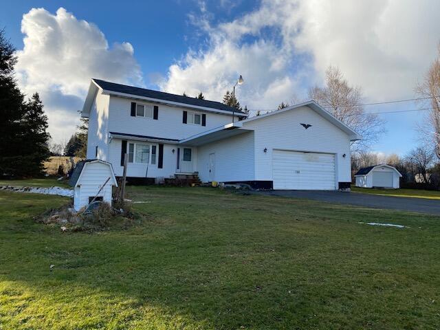 front of property featuring a garage and a front yard