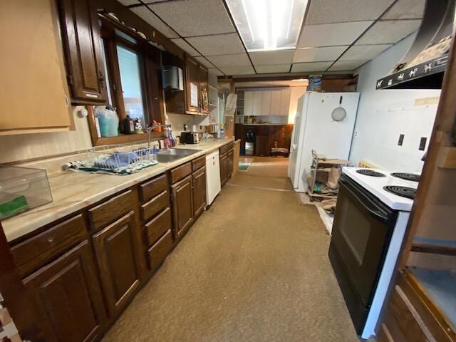 kitchen featuring ventilation hood, sink, a drop ceiling, and white appliances