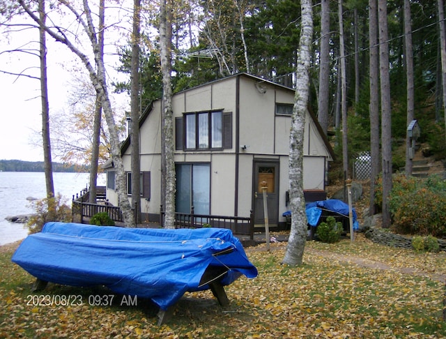 rear view of house featuring a water view