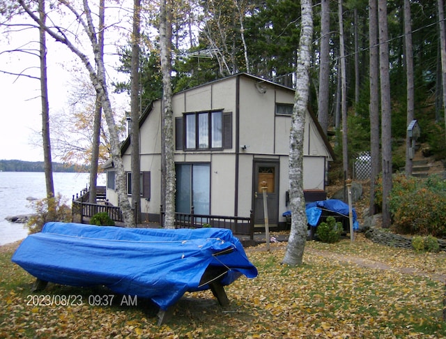 162 Hill Rd Unit T1 R9, Wels, ME 04462 - back of house featuring a water view and stucco siding