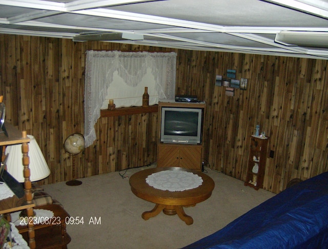 interior space with carpet, wood walls, and coffered ceiling