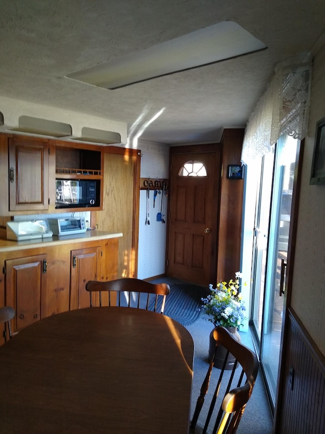 dining space featuring carpet flooring and a healthy amount of sunlight