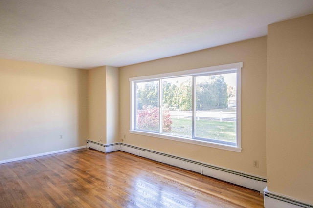 32 Morison Ave, Wells, ME 04090 - empty room with a baseboard radiator, wood finished floors, and baseboards
