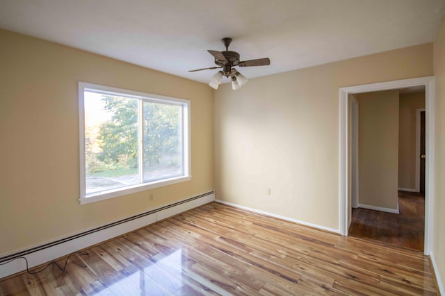 32 Morison Ave, Wells, ME 04090 - empty room featuring a baseboard heating unit, ceiling fan, baseboards, and light wood-type flooring