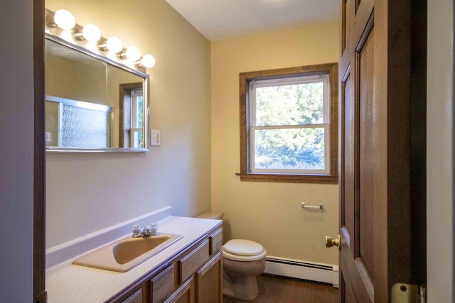 32 Morison Ave, Wells, ME 04090 - bathroom with vanity, wood finished floors, toilet, and a baseboard heating unit