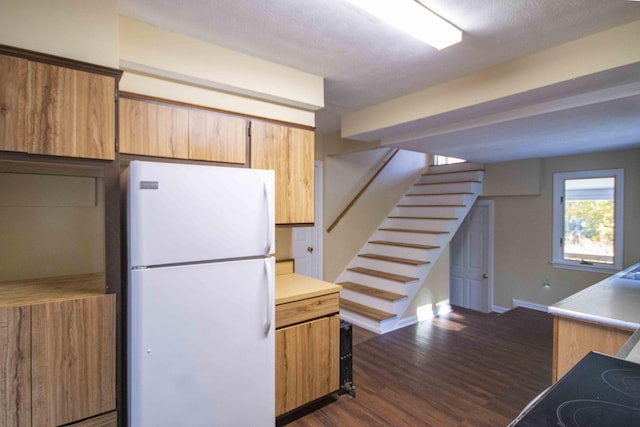 32 Morison Ave, Wells, ME 04090 - kitchen featuring dark wood-style floors, baseboards, light countertops, and freestanding refrigerator