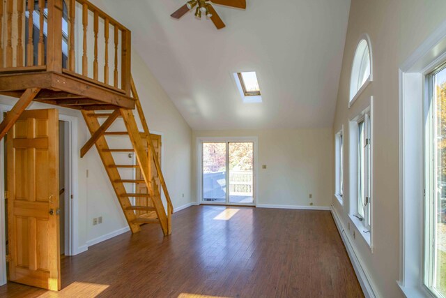 32 Morison Ave, Wells, ME 04090 - unfurnished living room with high vaulted ceiling, wood finished floors, a ceiling fan, and stairs