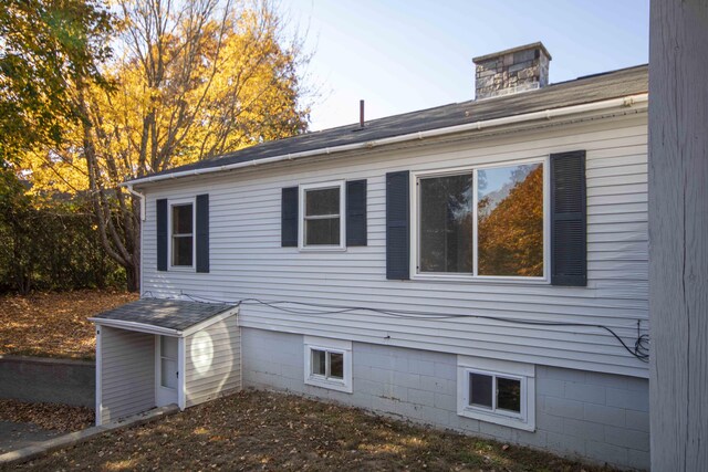 32 Morison Ave, Wells, ME 04090 - view of home's exterior with a shingled roof and a chimney