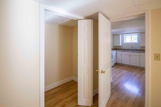 32 Morison Ave, Wells, ME 04090 - corridor with a drop ceiling, baseboards, light wood finished floors, and a sink