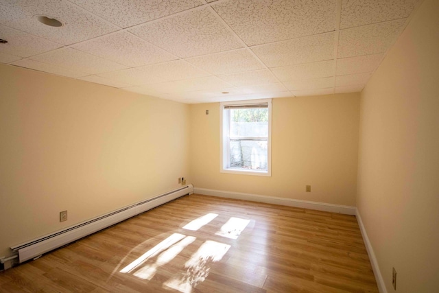 32 Morison Ave, Wells, ME 04090 - spare room featuring baseboard heating, wood finished floors, and a drop ceiling