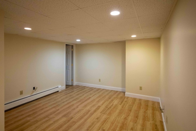 32 Morison Ave, Wells, ME 04090 - finished basement featuring a baseboard heating unit, baseboards, a drop ceiling, light wood-type flooring, and recessed lighting