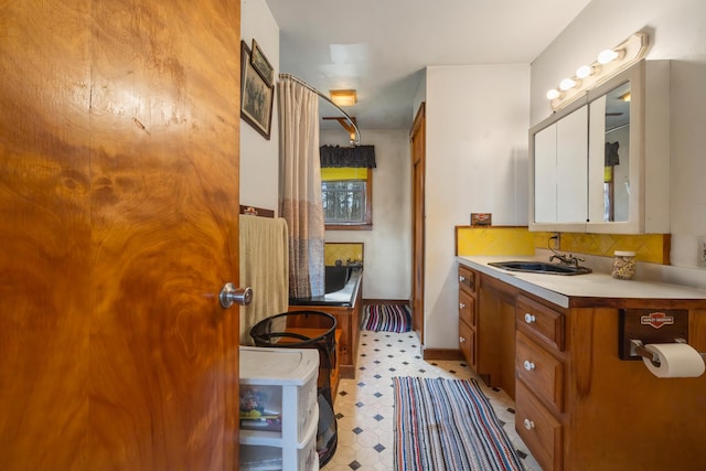 bathroom featuring decorative backsplash and vanity