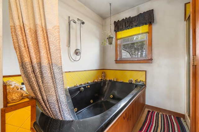 bathroom with tile patterned floors and a tub