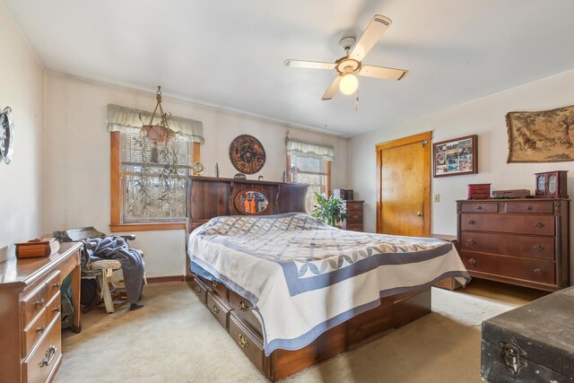 bedroom with ceiling fan and light colored carpet