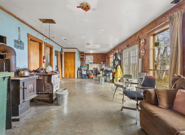 misc room with wood walls and concrete flooring