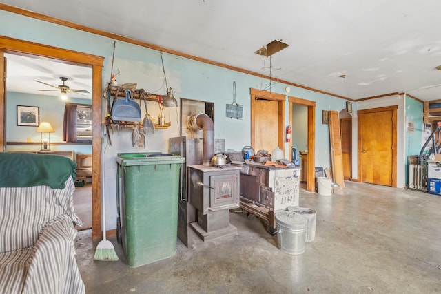 misc room with ceiling fan, concrete flooring, and ornamental molding