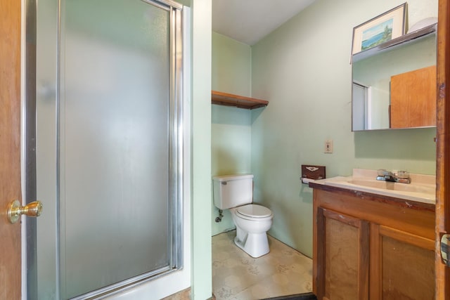 bathroom with vanity, an enclosed shower, and toilet