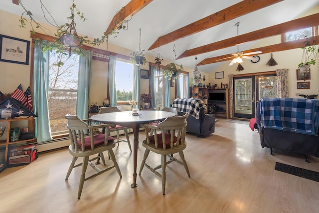 dining room with vaulted ceiling with beams, light hardwood / wood-style floors, a wealth of natural light, and ceiling fan