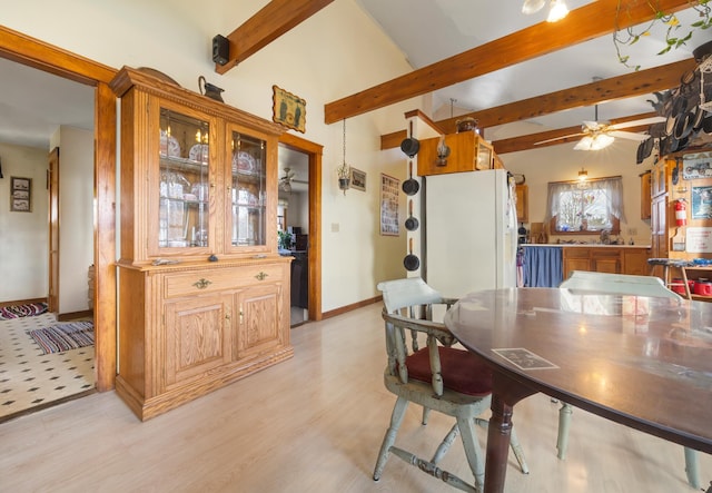 dining room featuring vaulted ceiling with beams, light wood-type flooring, and ceiling fan